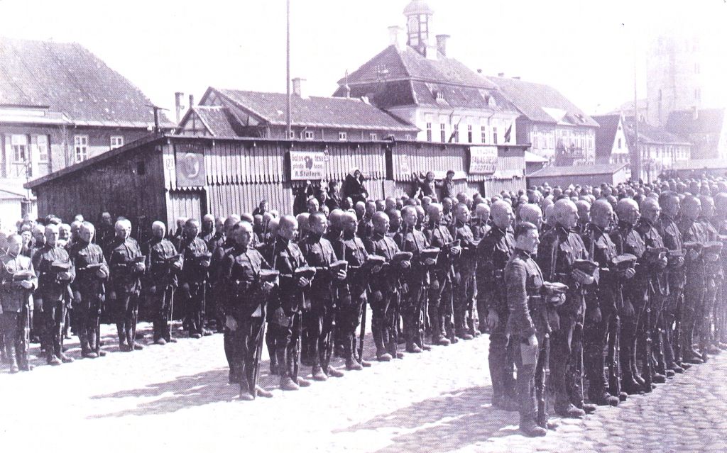 Svinīgs brīdis Jelgavas centrā, bijušajā tirgus laukumā.
Fonā rātsnams ar tornīti, kā arī Sv.Trīsvienības baznīca. 